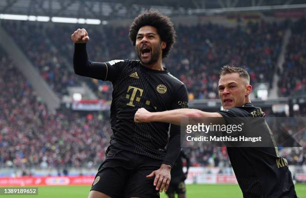 Serge Gnabry of FC Bayern Muenchen celebrates with teammate Joshua Kimmich after scoring their team's second goal during the Bundesliga match between...