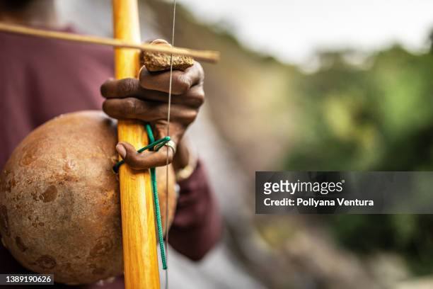 man playing berimbau - brazilian music stock pictures, royalty-free photos & images