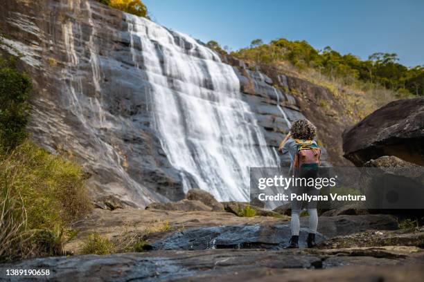 tourist taking photo of waterfall - in touch with nature stock pictures, royalty-free photos & images