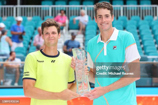 Hubert Hurkacz of Poland and John Isner pose with the Butch Buchholz Trophy after defeating Wesley Koolhof of the Netherlands and Neal Skupski of...