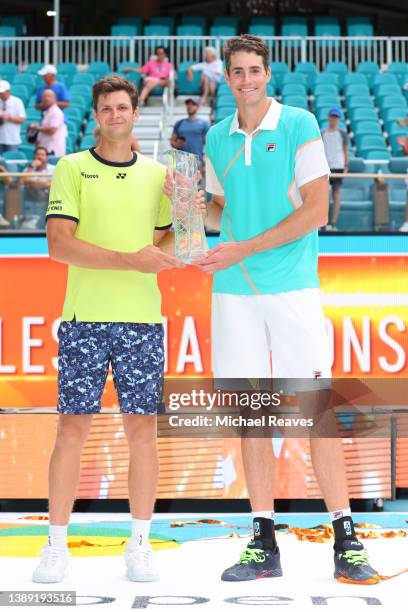 Hubert Hurkacz of Poland and John Isner pose with the Butch Buchholz Trophy after defeating Wesley Koolhof of the Netherlands and Neal Skupski of...