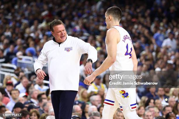 Head coach Bill Self high-fives Mitch Lightfoot of the Kansas Jayhawks during the game against the Villanova Wildcats in the semifinal game of the...