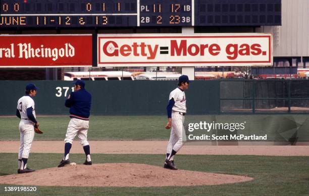 American baseball player Bud Harrelson , of the New York Mets, listens to team manager baseball team Yogi Berra during a game at Shea Stadium, in the...