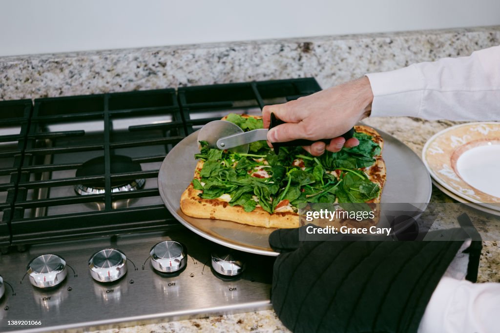 Man Slices Vegetarian Pizza