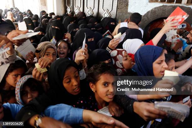 People affected by war wait to receive free meals provided by a charitable kitchen in the Mseek area on April 02, 2022 in Sana'a, Yemen. A two-month...