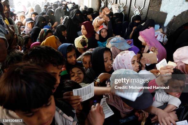 People affected by war wait to receive free meals provided by a charitable kitchen in the Mseek area on April 02, 2022 in Sana'a, Yemen. A two-month...