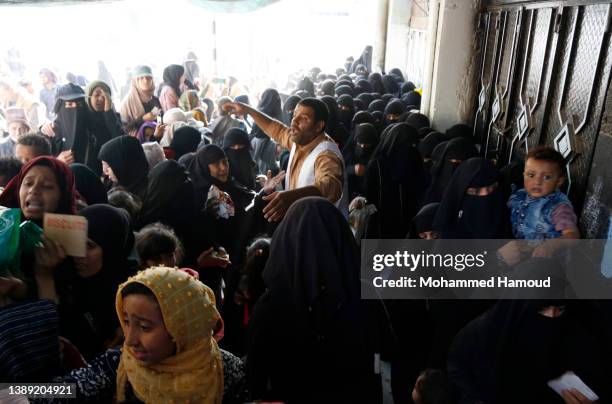 People affected by war wait to receive free meals provided by a charitable kitchen in the Mseek area on April 02, 2022 in Sana'a, Yemen. A two-month...