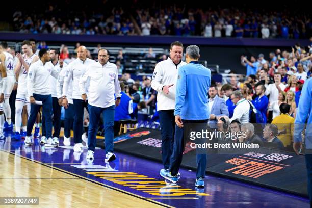 Head coach Bill Self of the Kansas Jayhawks shakes hands with head coach Jay Wright of the Villanova Wildcats after the semifinal game of the 2022...