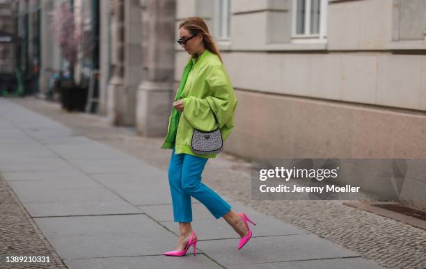 Sonia Lyson is seen wearing Lumina green light bomber jacket, Lumina green blouse, Lumina blue suit pants, Zara pink heels, Anine Bing shades and...