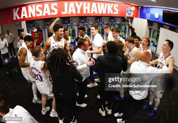 Head coach Bill Self of the Kansas Jayhawks celebrates with his team after defeating the Villanova Wildcats in the semifinal game of the 2022 NCAA...