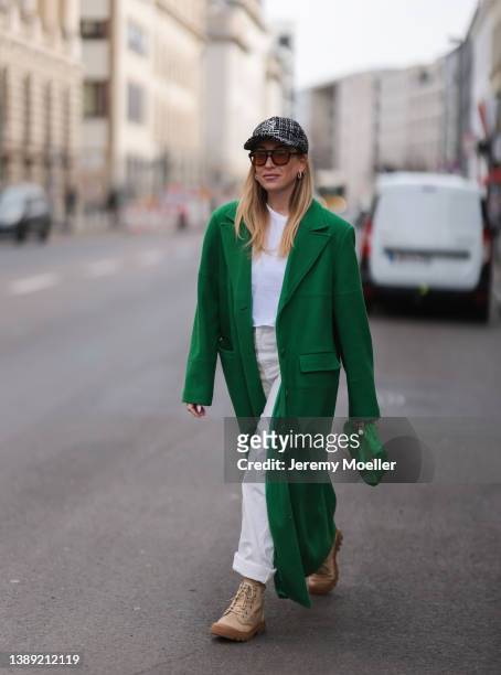 Sonia Lyson is seen wearing Saint Laurent black and white tweed cap, Vehla brown shades, Nakd green long coat, Zara white shirt, Bershka two colors...
