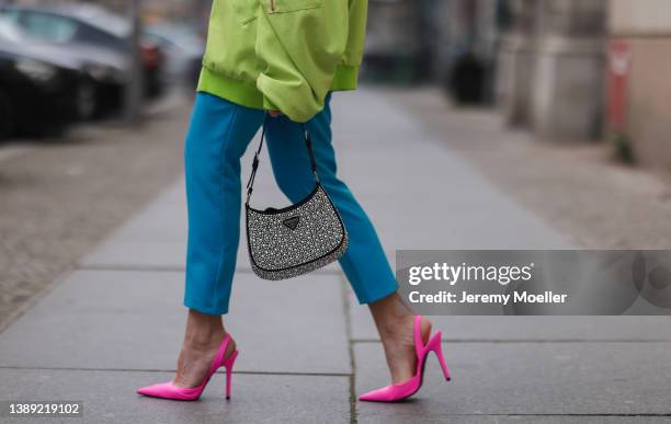 Sonia Lyson is seen wearing Lumina green light bomber jacket, Lumina green blouse, Lumina blue suit pants, Zara pink heelsand Prada sparkling Cleo...