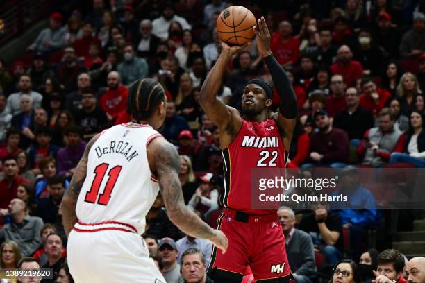 Jimmy Butler of the Miami Heat shoots a three point basket in the first half against DeMar DeRozan of the Chicago Bulls at United Center on April 02,...