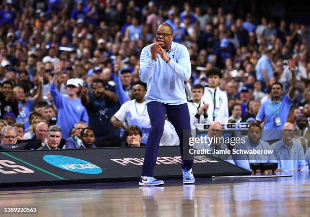 Head coach Hubert Davis of the North Carolina Tar Heels coaches from the bench as they take on the Duke Blue Devils during the first half in the...