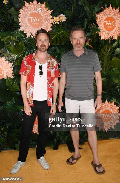 Actor Aaron Paul and actor Bryan Cranston arrive at Tao Beach Dayclub opening at The Venetian® Resort Las Vegas on April 02, 2022 in Las Vegas,...