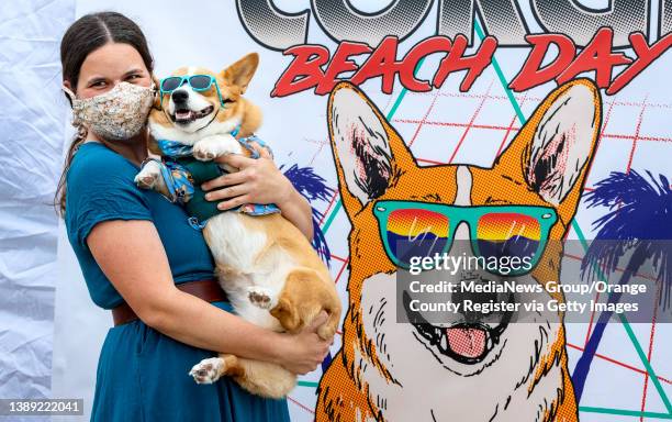 Huntington Beach, CA Jennifer Hendricks of Tustin holds Arlo in front of a backdrop at the annual Corgi Beach Day at Huntington Beach on Saturday,...