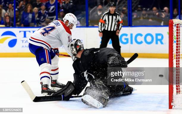 Nick Suzuki of the Montreal Canadiens scores the game winning goal in a shootout against Brian Elliott of the Tampa Bay Lightning during a game at...