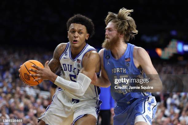 Paolo Banchero of the Duke Blue Devils drives against Brady Manek of the North Carolina Tar Heels in the second half of the game during the 2022 NCAA...