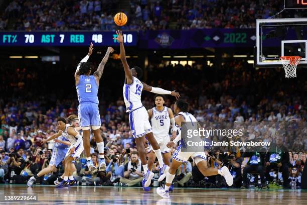 Caleb Love of the North Carolina Tar Heels shoots the ball over Mark Williams of the Duke Blue Devils during the second half in the semifinal game of...