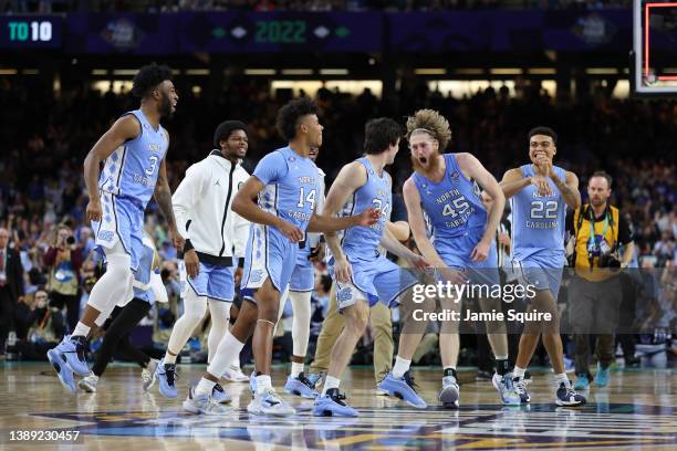 North Carolina Tar Heels players react after defeating the Duke Blue Devils 81-77 in the second half of the game during the 2022 NCAA Men's...