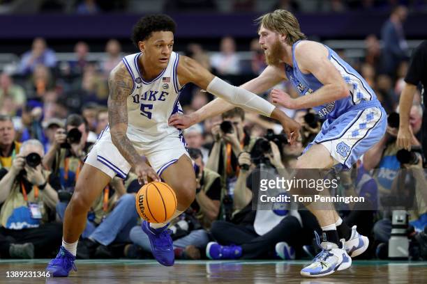 Paolo Banchero of the Duke Blue Devils dribbles the ball around Brady Manek of the North Carolina Tar Heels in the second half of the game during the...