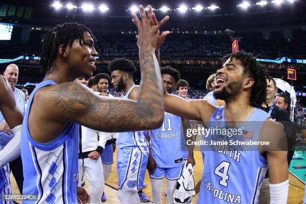 Davis of the North Carolina Tar Heels and Caleb Love of the North Carolina Tar Heels celebrate a win against the Duke Blue Devils during the...