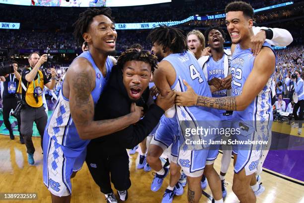 Members of the North Carolina Tar Heels celebrate a win against the Duke Blue Devils during the second half in the semifinal game of the 2022 NCAA...