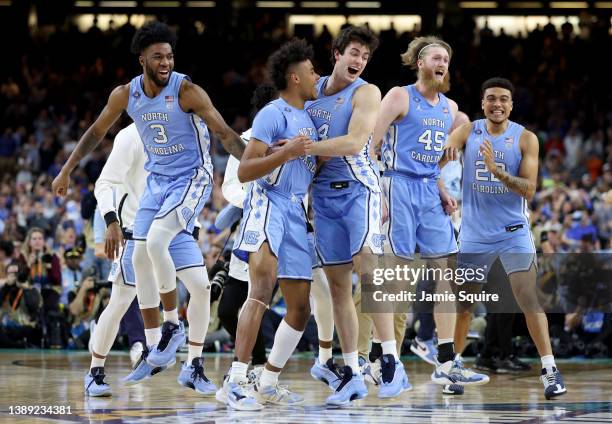 North Carolina Tar Heels players react after defeating the Duke Blue Devils 81-77 in the second half of the game during the 2022 NCAA Men's...