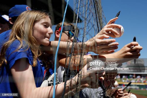 Young fans ask for player autographs before the MLB spring training game between the Chicago Cubs and the Los Angeles Angels at Sloan Park on April...