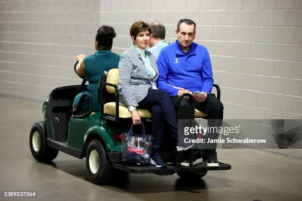 Head coach Mike Krzyzewski of the Duke Blue Devils and his wife Mickie Krzyzewski leave a press conference after the team's loss to the North...