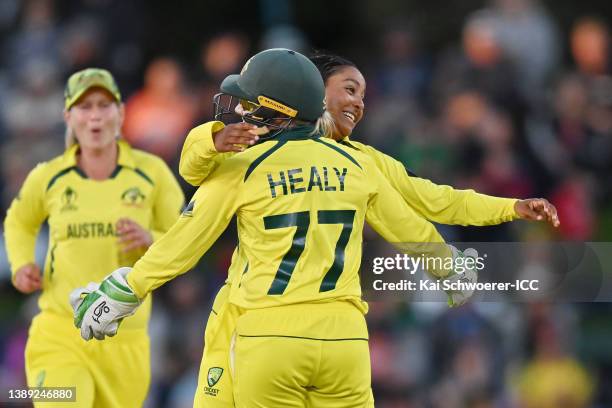 Alana King of Australia celebrates with teammate Alyssa Healy after dismissing Heather Knight of England during the 2022 ICC Women's Cricket World...