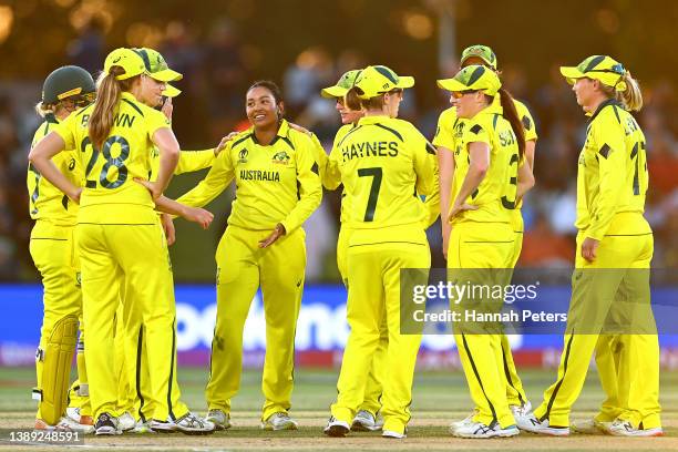 Alana King of Australia celebrates with team mates after dismissing Heather Knight of England during the 2022 ICC Women's Cricket World Cup Final...