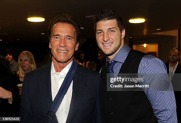 Former Governor of California Arnold Schwarzenegger and NFL Player Tim Tebow of the Denver Broncos arrive at the premiere of Relativity Media's "Act...