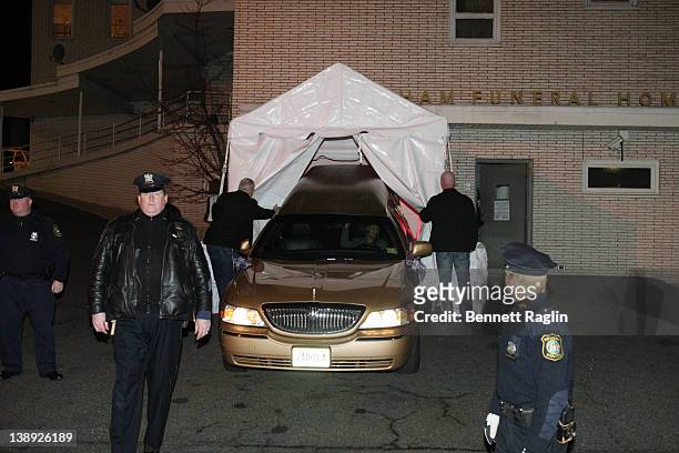 The car carrying Whitney Houston's body arrives at Whigham Funeral Home ahead of her funeral on February 13, 2012 in Newark, New Jersey.