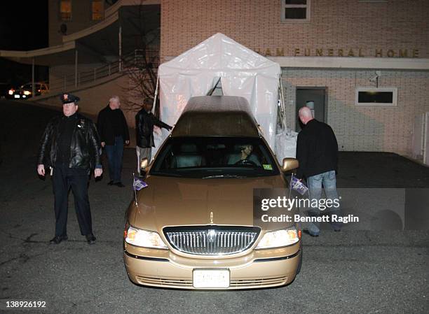 The car carrying Whitney Houston's body arrives at Whigham Funeral Home ahead of her funeral on February 13, 2012 in Newark, New Jersey.