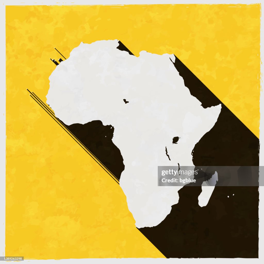 Africa map with long shadow on textured yellow background