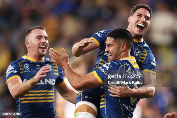 Dylan Brown of the Eels celebrates with Clinton Gutherson and Mitchell Moses of the Eels after scoring a try during the round four NRL match between...
