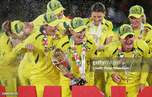 Meg Lanning of Australia celebrates with teammates and the trophy after winning the 2022 ICC Women's Cricket World Cup Final match between Australia...