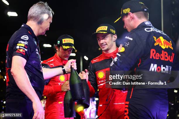 Max Verstappen of Netherlands and Red Bull Racing celebrates on the podium with Red Bull Racing Head of Car Engineering Paul Monaghan, Charles...