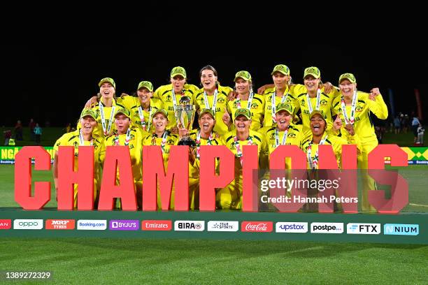 Australia celebrate with the trophy after winning the 2022 ICC Women's Cricket World Cup Final match between Australia and England at Hagley Oval on...