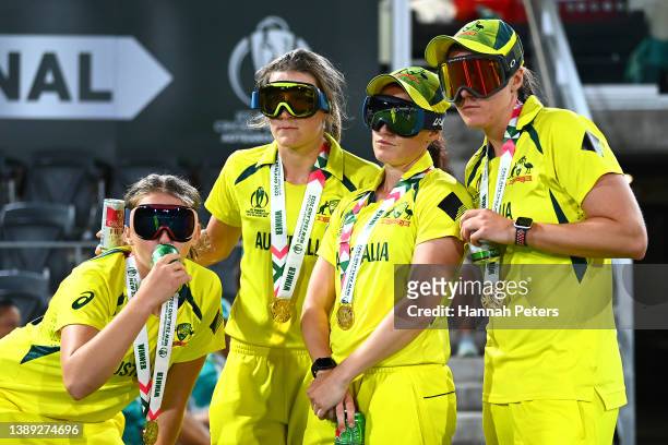 Australia players Annabel Sutherland, Megan Schutt, Darcie Brown and Tahlia McGrath take selfies wearing ski masks after Australia won the 2022 ICC...