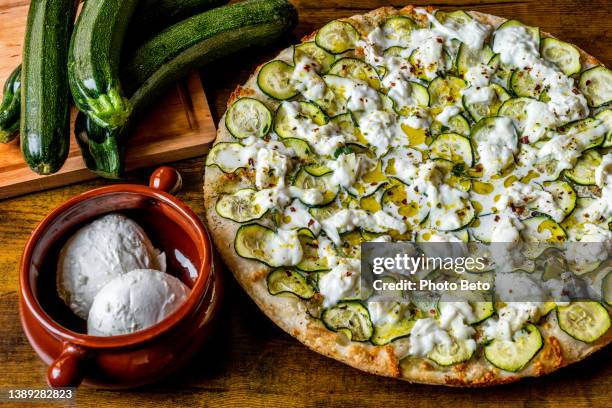 a delicious and typical italian pizza with zucchini, mozzarella and stracchino fresh cheese - courgette stock pictures, royalty-free photos & images