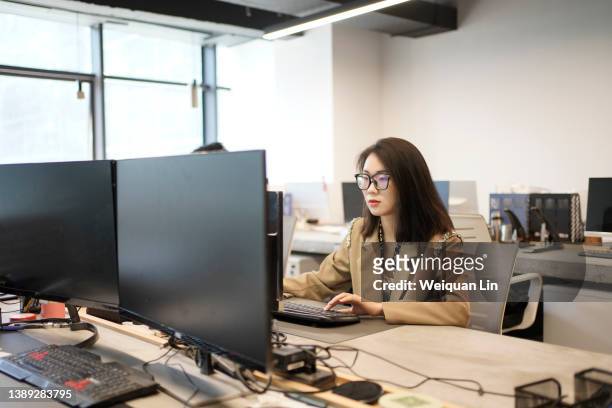 Asian young woman working in office