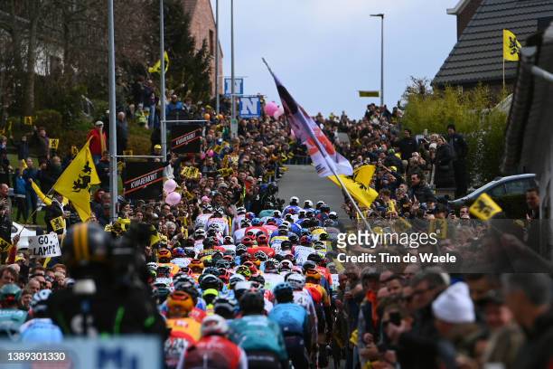General view of the Peloton passing through Berendries while fans cheer during the 106th Ronde van Vlaanderen - Tour des Flandres 2022 - Men's Elite...