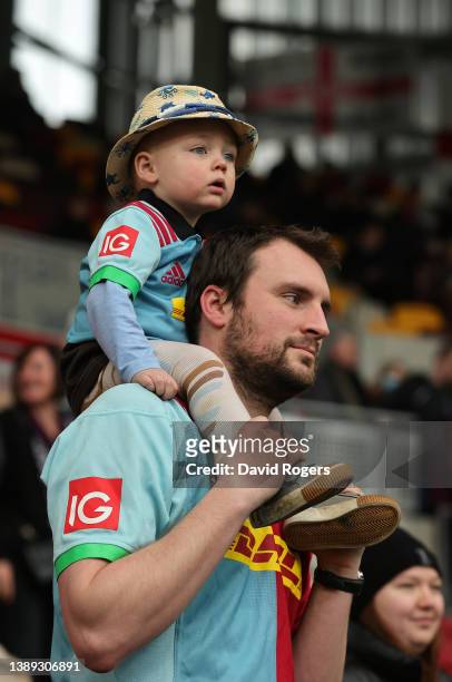 Young Harlequins fan and his father look on during the Gallagher Premiership Rugby match between London Irish and Harlequins at Brentford Community...