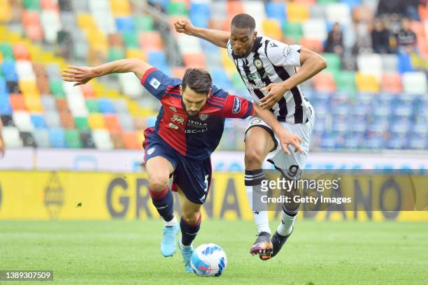 Goldaniga of Cagliari Calcio competes for the ball with Beto of Udinese Calcio during the Serie A match between Udinese Calcio and Cagliari Calcio at...