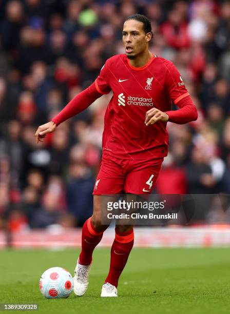 Virgil van Dijk of Liverpool runs with the ball during the Premier League match between Liverpool and Watford at Anfield on April 02, 2022 in...