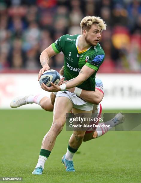 Ollie Hassell-Collins of London Irish breaks through the tackle of Huw Jones of Harlequins during the Gallagher Premiership Rugby match between...