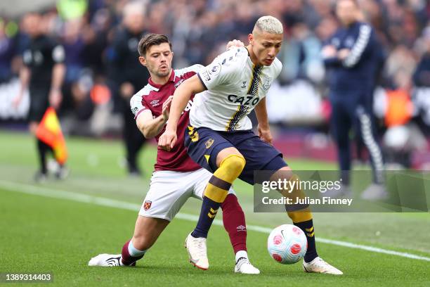 Richarlison of Everton holds off Aaron Cresswell of West Ham United during the Premier League match between West Ham United and Everton at London...