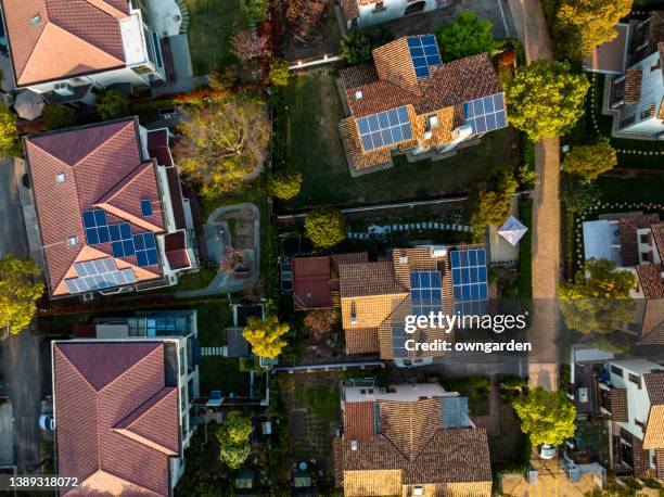 solar panels on home rooftop - dach stock-fotos und bilder